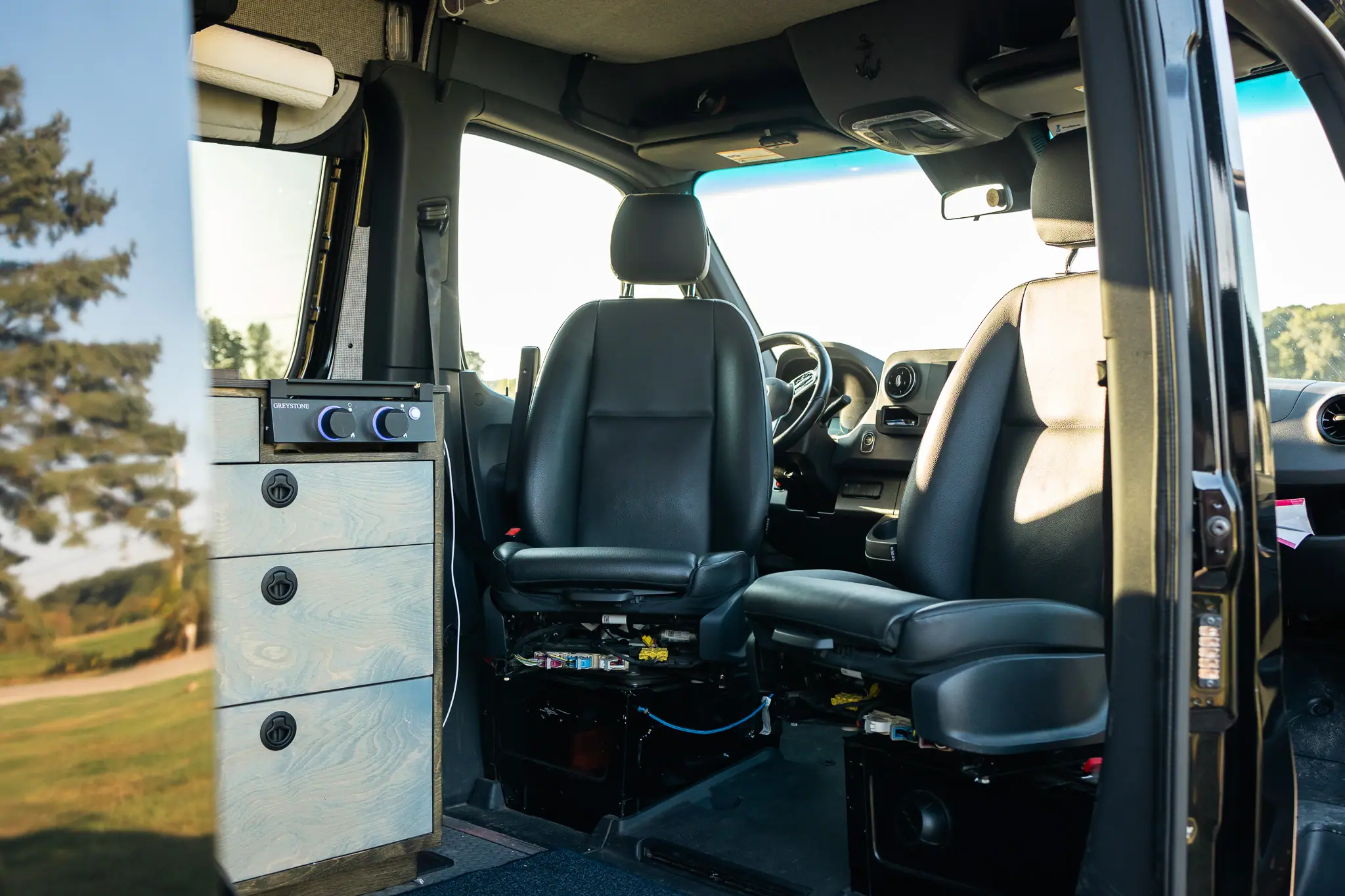 Sprinter camper van front seats on swivel bases, turned to face the living area