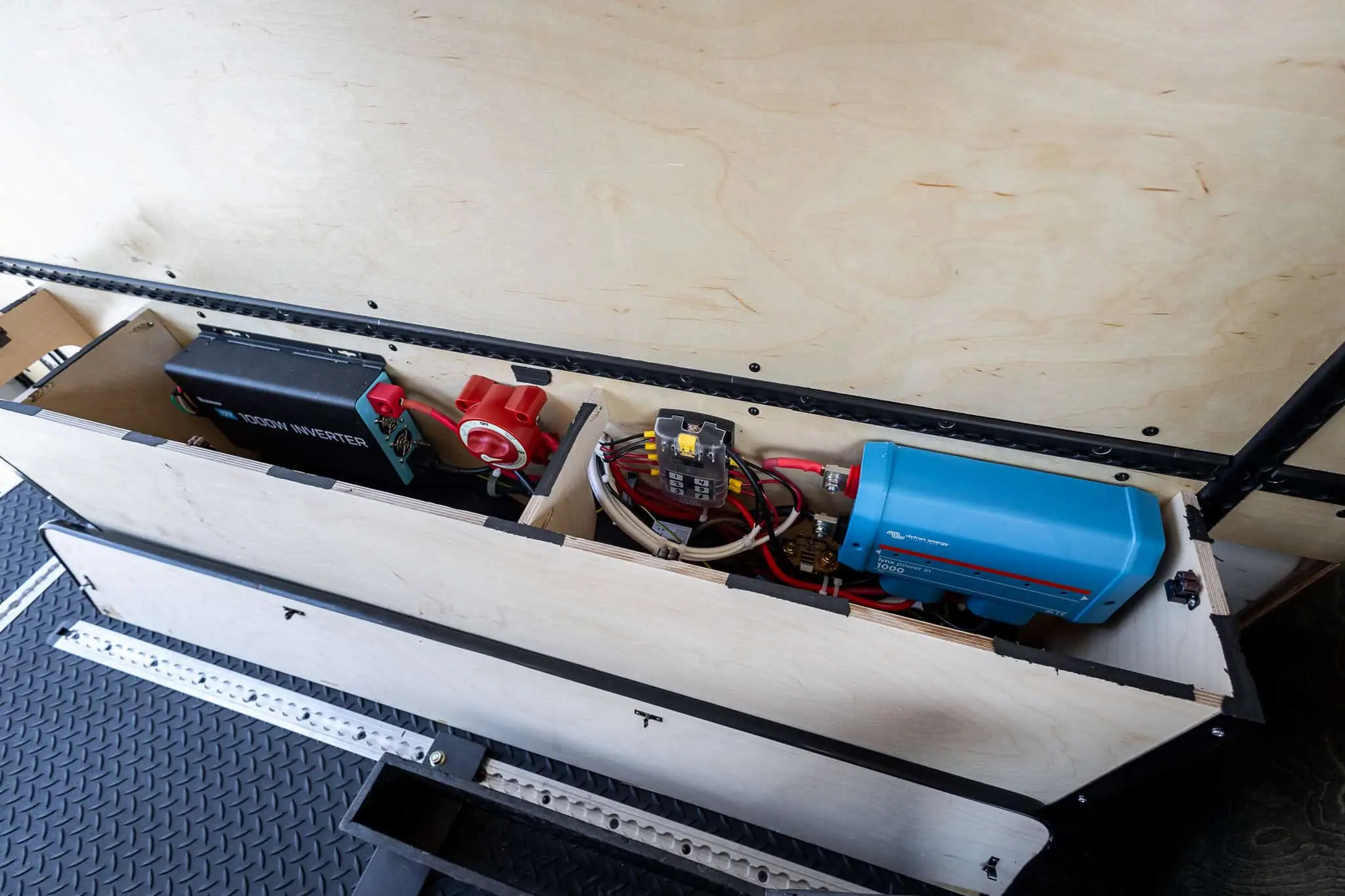 Van electrical system with an inverter, battery disconnect switch, fuse block and busbar in a plywood box